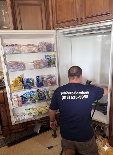 Certified Sub-Zero technician repairing a built-in freezer in Miami